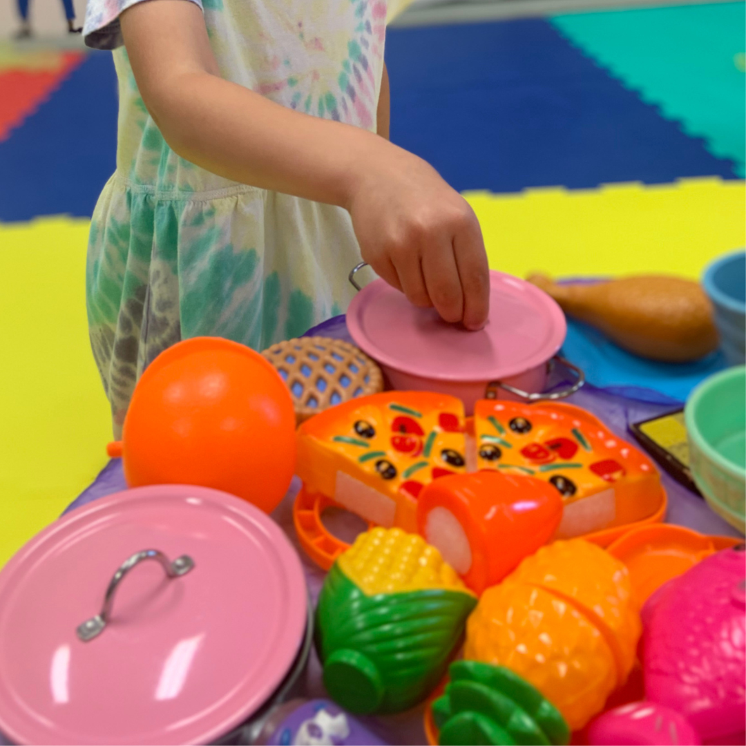 Child roleplaying with food toys
