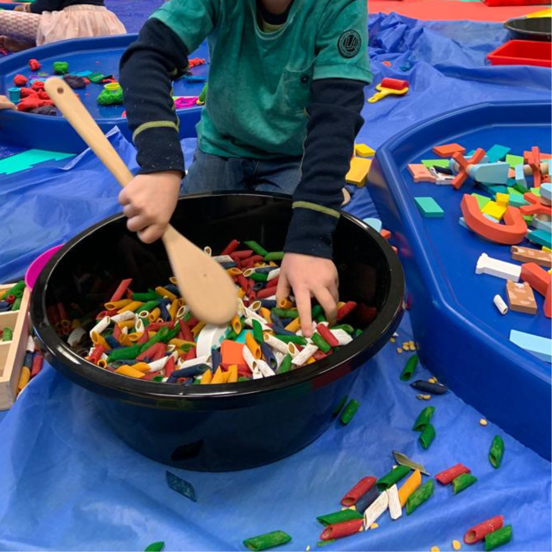 Big kid playing with pasta